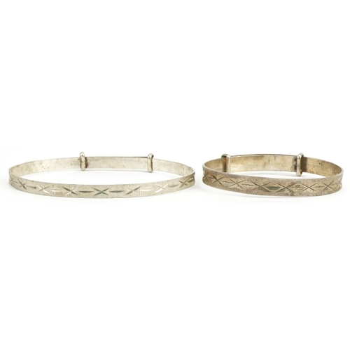 2605 - Two silver christening bangles with engraved decoration, one hallmarked 1973, total 9.1g