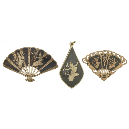 2628 - Two Thai Siam fan brooches with niello work dancers and a similar pendant, the largest 5.5cm wide, t... 