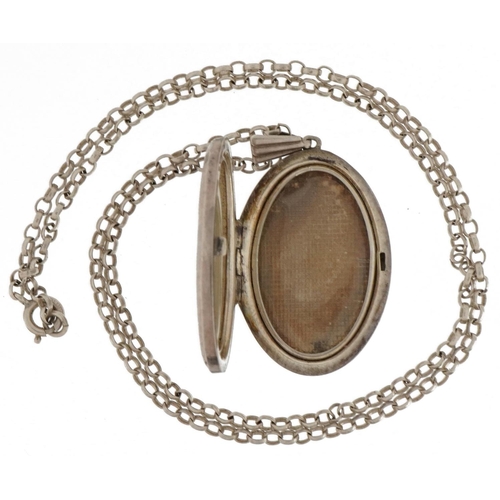 2590 - Silver oval locket with floral decoration on a silver Belcher link necklace, 4.0cm high and 45cm in ... 