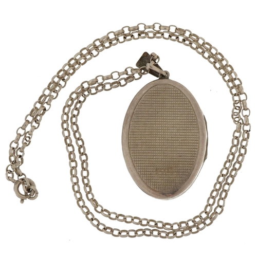 2590 - Silver oval locket with floral decoration on a silver Belcher link necklace, 4.0cm high and 45cm in ... 