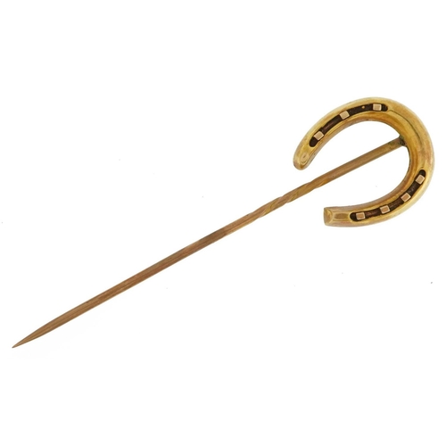 2469 - Victorian unmarked gold horseshoe stickpin, tests as 15ct gold, housed in a Cook & Burchett Oxford S... 