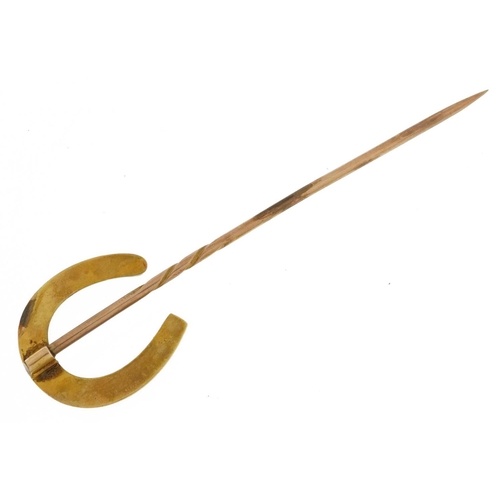 2469 - Victorian unmarked gold horseshoe stickpin, tests as 15ct gold, housed in a Cook & Burchett Oxford S... 