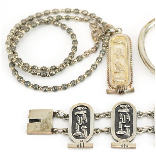 2661 - Egyptian Revival silver jewellery comprising two bust brooches, hieroglyphic pendant on chain, cuff ... 