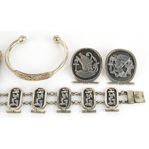 2661 - Egyptian Revival silver jewellery comprising two bust brooches, hieroglyphic pendant on chain, cuff ... 