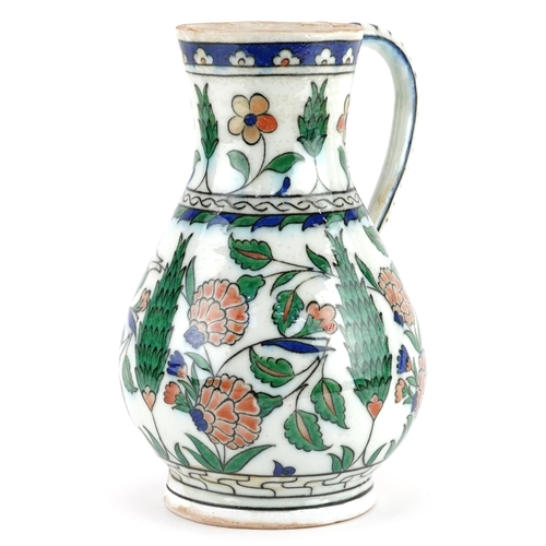 266 - Turkish Ottoman Iznik water jug hand painted with stylised flowers and foliage, 24.5cm high