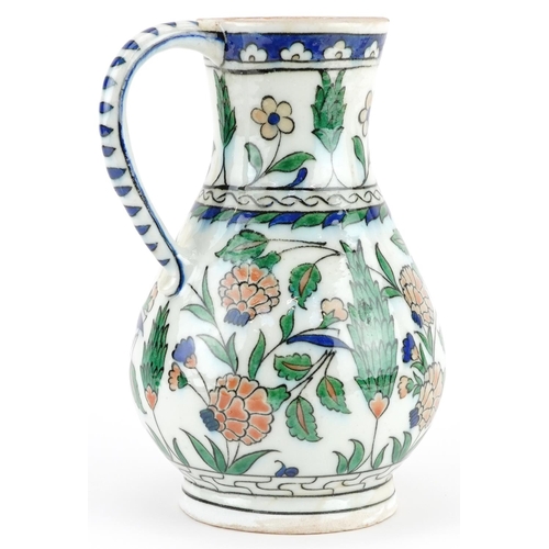 266 - Turkish Ottoman Iznik water jug hand painted with stylised flowers and foliage, 24.5cm high