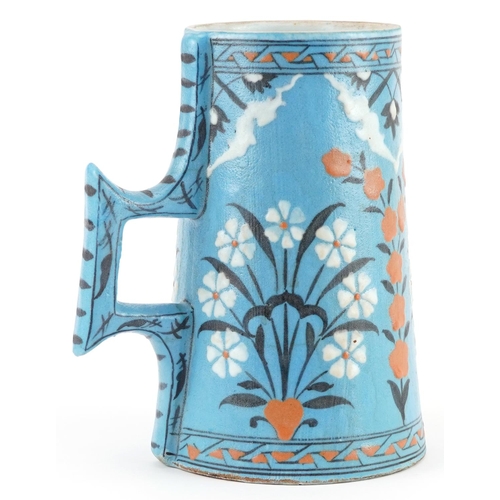 53 - Turkish Ottoman Iznik tankard with tapering body hand painted with stylised flowers, 20.5cm high