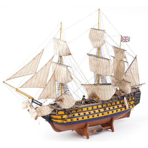 365 - Large hand painted wooden model of HMS Victory on stand together with a Del Prado figure of Vice Adm... 