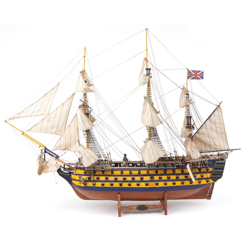 365 - Large hand painted wooden model of HMS Victory on stand together with a Del Prado figure of Vice Adm... 