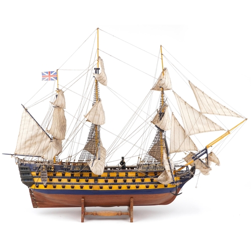 365 - Large hand painted wooden model of HMS Victory on stand together with a Del Prado figure of Vice Adm... 