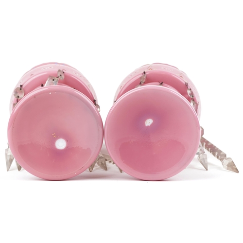  Pair of Victorian pink opaline glass lustres with drops, each enamelled with flowers, each 31.5cm hi... 