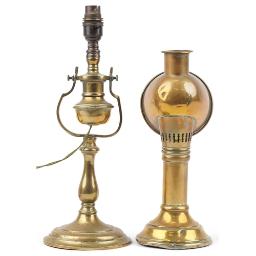 579 - Two antique brass lamps comprising a candle lamp by Veritas Lamp Works and a shipping interest gimba... 