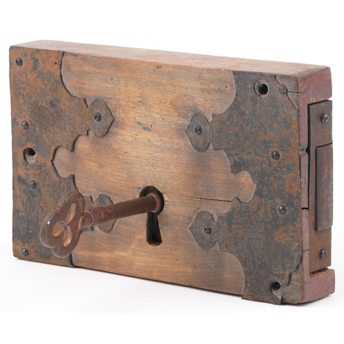 96 - Antique wooden lock with iron mounts and key, 25.5cm x 16cm