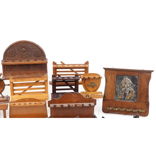 1494 - Collection of smoking interest wooden pipe racks including an Indian example profusely carved with f... 