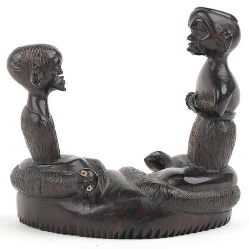 1362 - African tribal interest hardwood carving of two figures and two serpents, 10cm wide