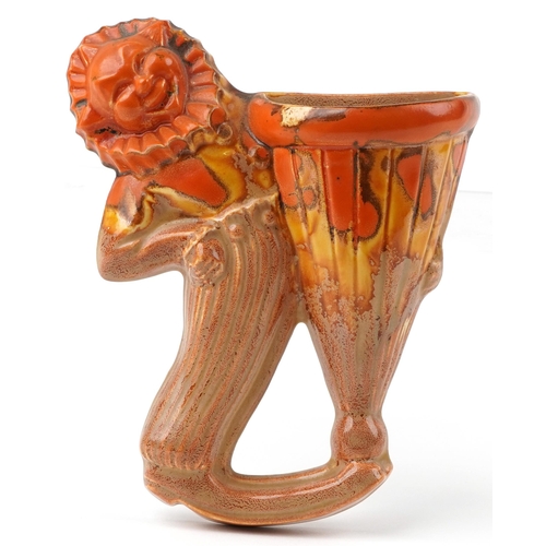 111 - Clarice Cliff, Art Deco pottery wall pocket in the form of a clown hugging a vase, 19cm high