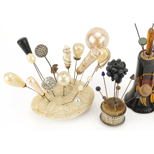 293 - Collection of early 20th century and later hatpins arranged in four hatpin stands including two silv... 