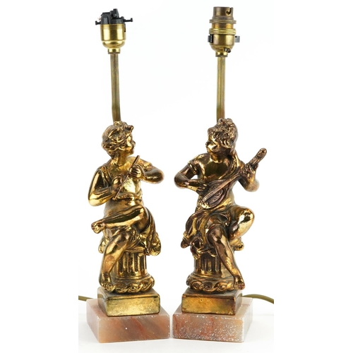 1303 - Pair of classical gilt painted, brass and onyx table lamps, each in the form of musicians seated on ... 