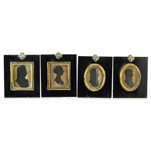 243 - Four Georgian hand painted silhouette portrait miniatures housed in ebonised framed with brass mount... 