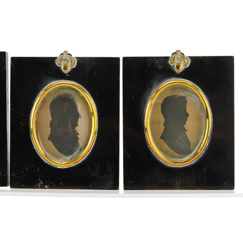 243 - Four Georgian hand painted silhouette portrait miniatures housed in ebonised framed with brass mount... 