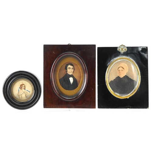 242 - Three Georgian and later hand painted portrait miniatures including one of a gentleman wearing a bla... 