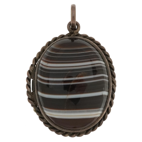 2569 - Unmarked silver locket set with two Scottish agate cabachons, 3.5cm high, 16.4g