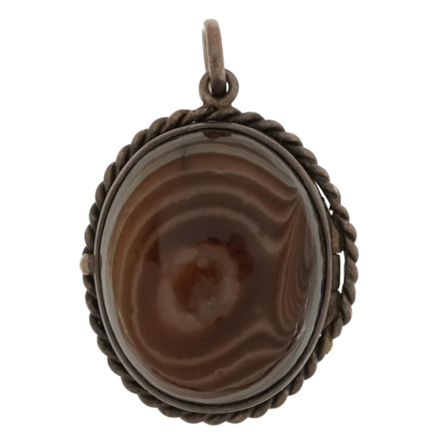 2569 - Unmarked silver locket set with two Scottish agate cabachons, 3.5cm high, 16.4g