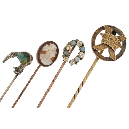 2576 - Four yellow and white metal stickpins including one unmarked gold and a cameo shell carved with a ma... 