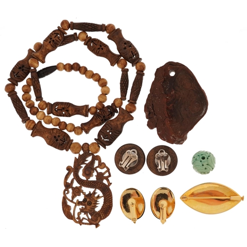 2716 - Chinese and Japanese jewellery including a Chinese carved bone necklace with dragon pendant, burl wo... 