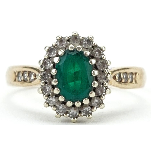 2245 - 9ct gold emerald and diamond cluster ring with diamond set shoulders, the emerald approximately 6.0m... 