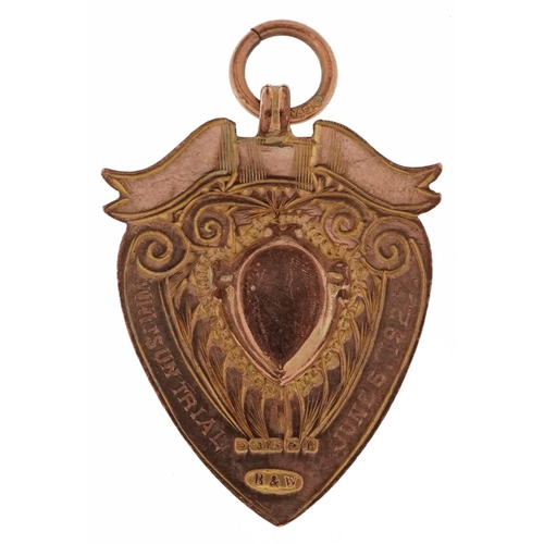 2159 - George V 9ct rose gold shield shaped sports jewel, Birmingham 1926, 3.2cm high, 4.9g