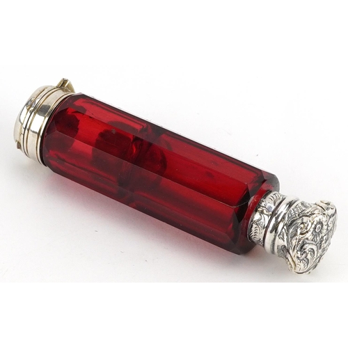 64 - Victorian ruby glass double ended scent bottle with unmarked silver mounts, 10cm in length