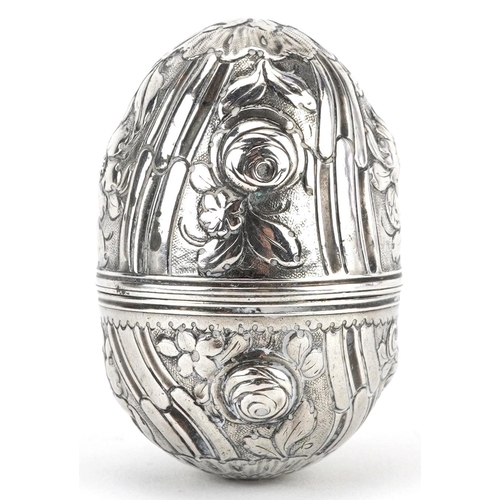 234 - Unmarked silver trinket box in the form of an egg embossed with flowers and foliage, 5cm high, 15.4g