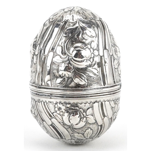 234 - Unmarked silver trinket box in the form of an egg embossed with flowers and foliage, 5cm high, 15.4g