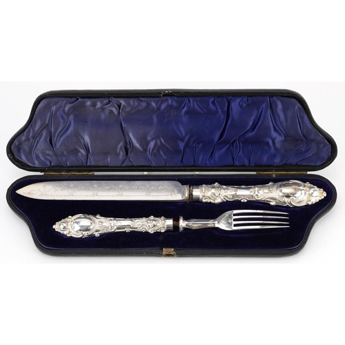 1319 - Victorian silver handled knife and fork with silver plated blades housed in a velvet and silk lined ... 