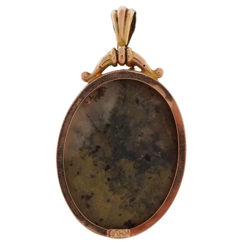 2197 - 9ct gold pendant set with a hardstone cabochon, 4.5cm high, 10.5g