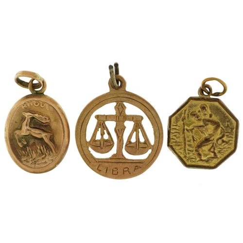 2550 - Three 9ct gold charms comprising zodiac Libra, St Christopher and Rhodes souvenir embossed with a fl... 