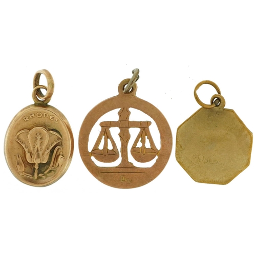 2550 - Three 9ct gold charms comprising zodiac Libra, St Christopher and Rhodes souvenir embossed with a fl... 