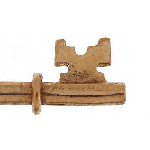 2556 - Two 9ct gold charms comprising trumpet and a key, the largest 2.5cm high, total 2.1g