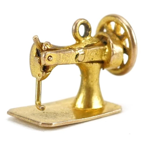 2155 - 9ct gold charm in the form of a sewing machine with moving parts, 1.3cm wide, 1.3g