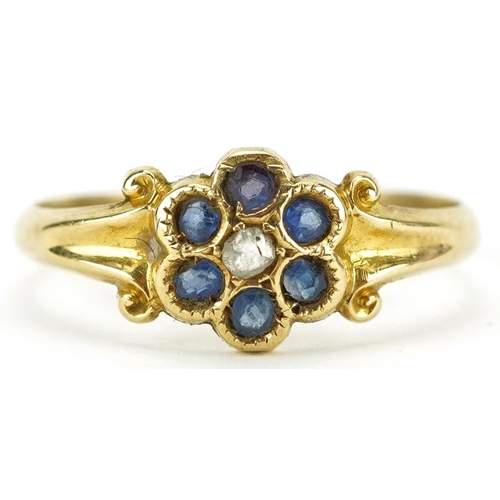 2446 - 18ct gold diamond and blue stone flower head ring with scrolled shoulders, size N/O, 2.1g