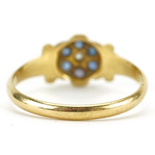 2446 - 18ct gold diamond and blue stone flower head ring with scrolled shoulders, size N/O, 2.1g