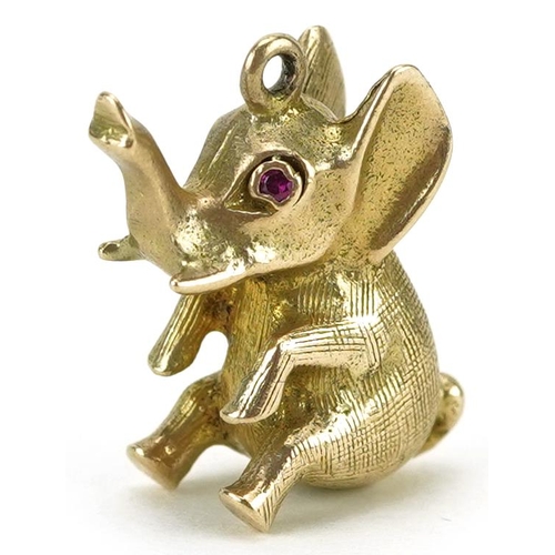 2204 - 9ct gold charm in the form of a seated elephant with a ruby eye, 2cm high, 5.0g