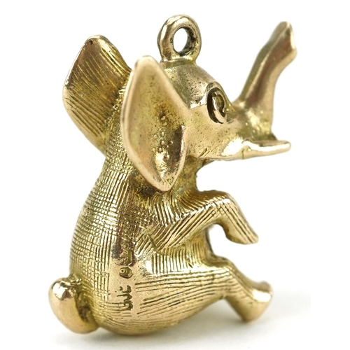 2204 - 9ct gold charm in the form of a seated elephant with a ruby eye, 2cm high, 5.0g