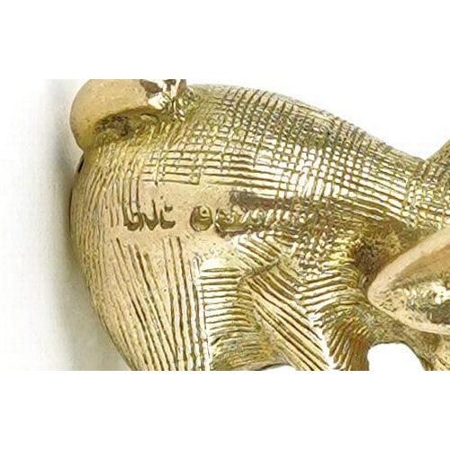 2204 - 9ct gold charm in the form of a seated elephant with a ruby eye, 2cm high, 5.0g