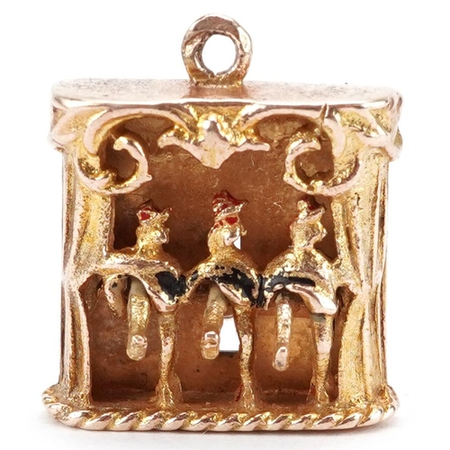 2241 - 9ct gold charm in the form of three can-can dancers with moving legs, 1.5cm high, 3.1g