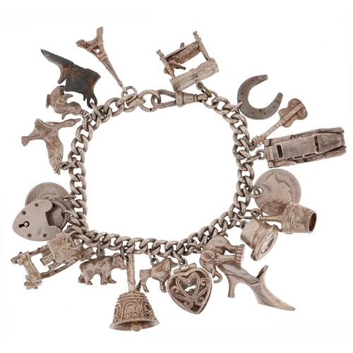 2713 - Silver charm bracelet with a collection of mostly silver charms including classic cars, engagement r... 