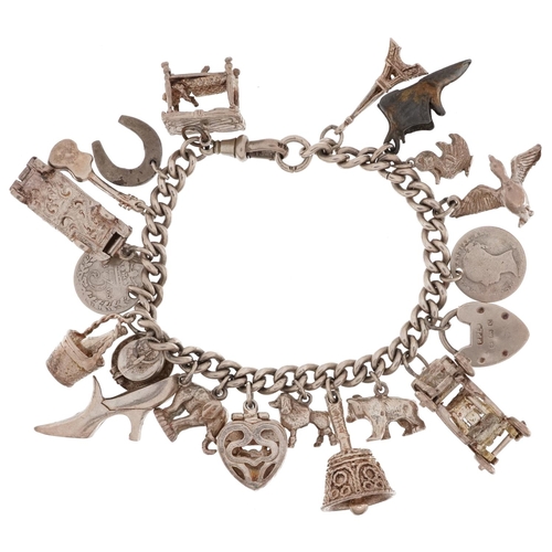 2713 - Silver charm bracelet with a collection of mostly silver charms including classic cars, engagement r... 