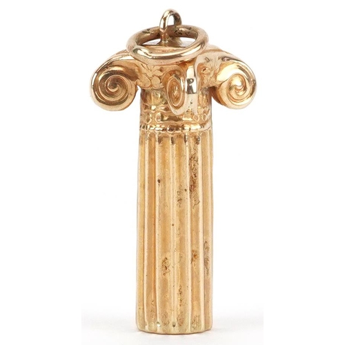 2429 - 18ct gold charm in the form of a Corinthian column, 2.3cm high, 1.6g