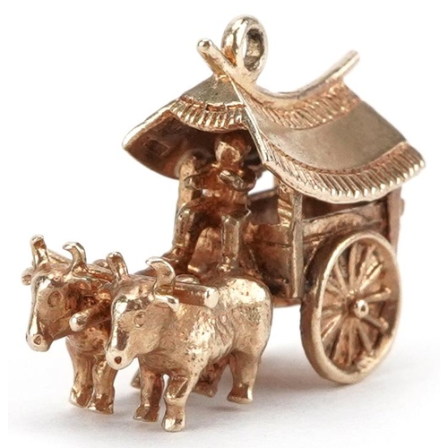 2016 - 9ct gold charm in the form of two oxen pulling an Indonesian cart, 2.1cm in length, 4.9g